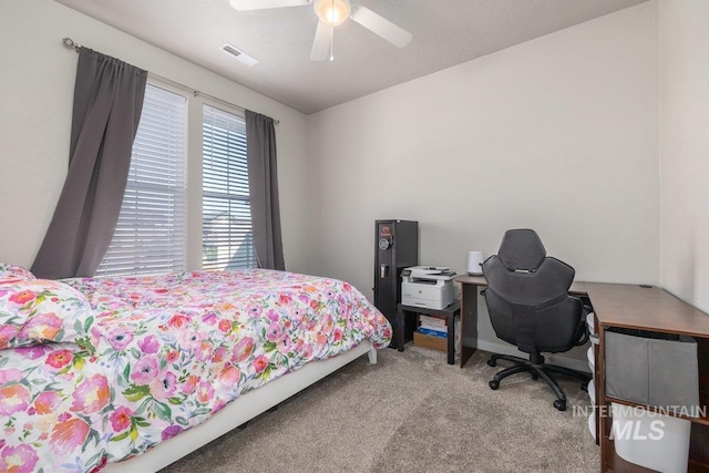 carpeted bedroom featuring ceiling fan and visible vents