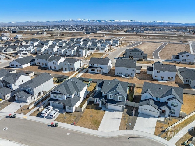 drone / aerial view featuring a residential view and a mountain view