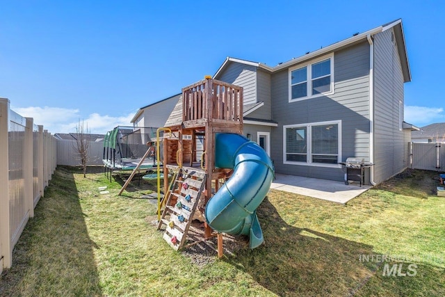 view of jungle gym with a fenced backyard, a trampoline, a patio, and a yard