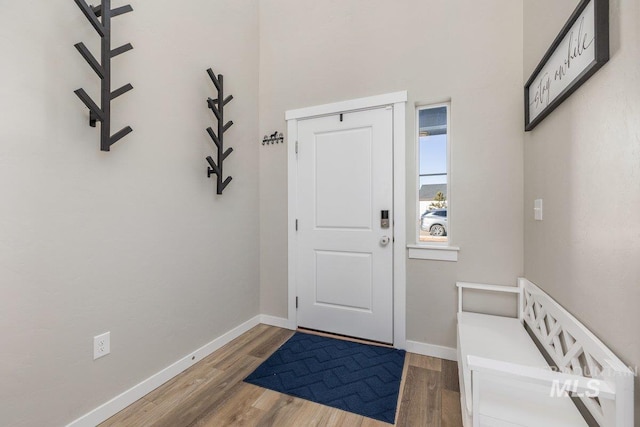 entryway with wood finished floors and baseboards