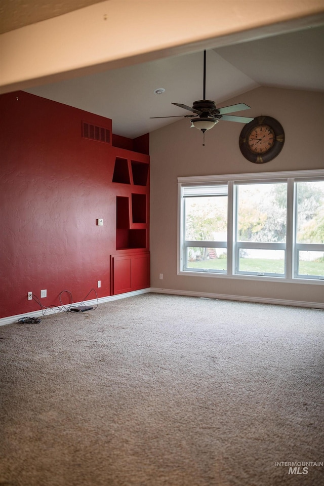 unfurnished living room with ceiling fan, carpet, and vaulted ceiling