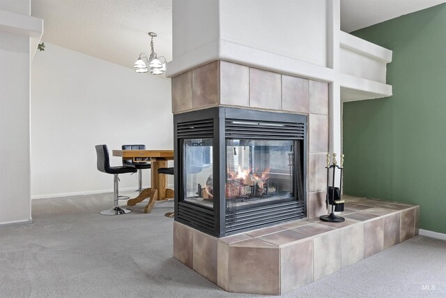 9788 Hwy 78, Hammett, ID 83627 - details with a chandelier, carpet, a tile fireplace, and baseboards
