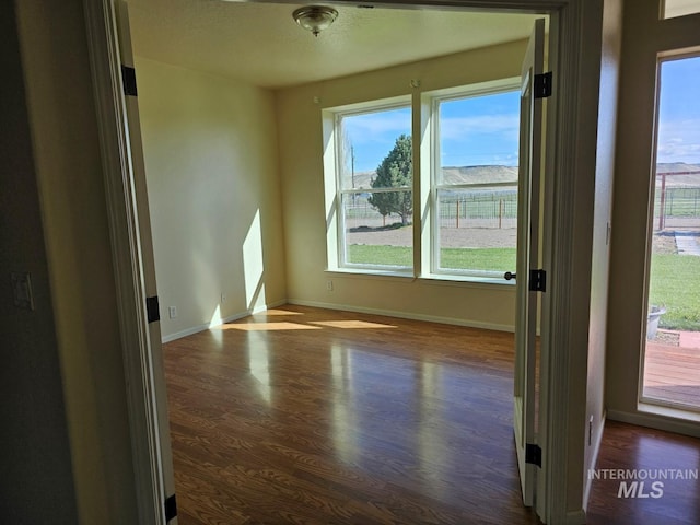 9788 Hwy 78, Hammett, ID 83627 - unfurnished room with dark wood-type flooring and baseboards