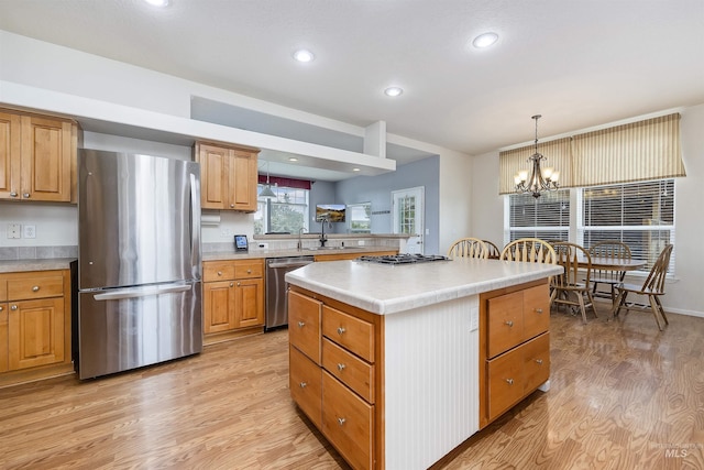 9788 Hwy 78, Hammett, ID 83627 - kitchen featuring an inviting chandelier, light wood-style flooring, light countertops, a kitchen island, and stainless steel appliances