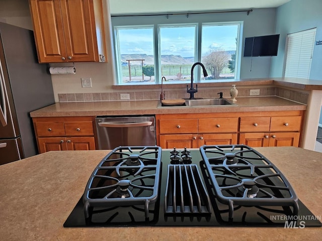 9788 Hwy 78, Hammett, ID 83627 - kitchen featuring light countertops, brown cabinets, appliances with stainless steel finishes, and a sink