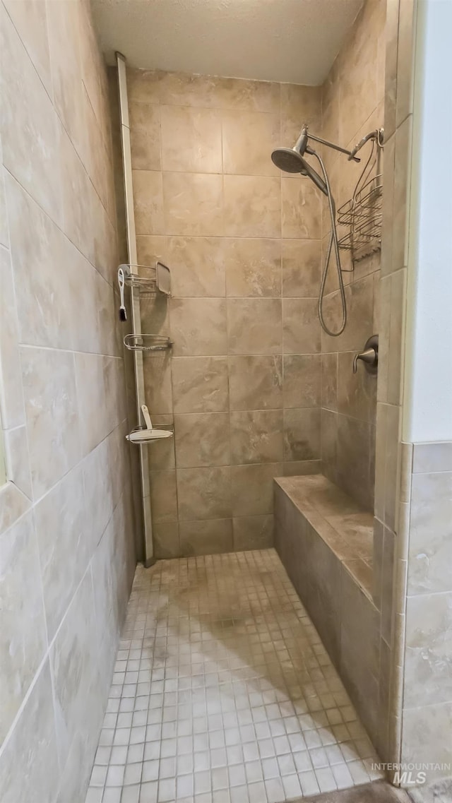 full bath featuring a tile shower