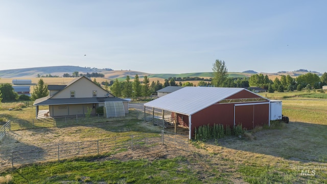 view of outdoor structure featuring an exterior structure, an outdoor structure, a mountain view, and a rural view