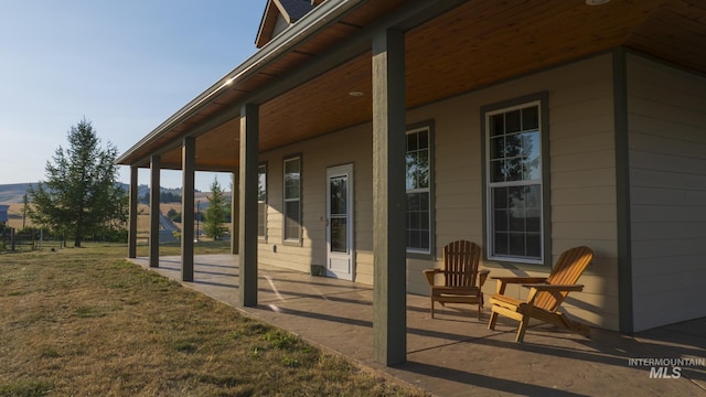 view of side of home with a yard and a patio