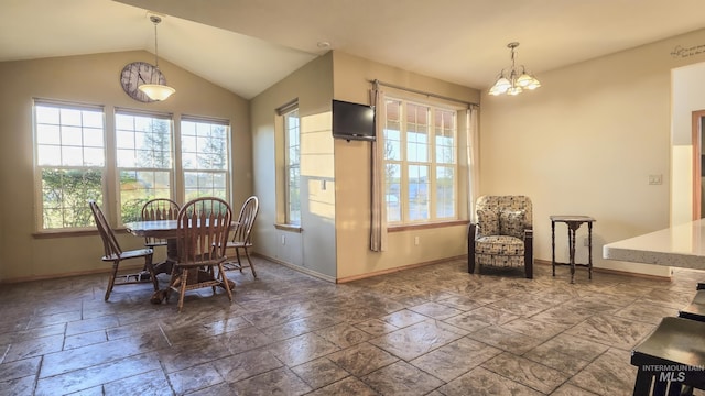 dining room with a chandelier, baseboards, vaulted ceiling, and stone tile flooring