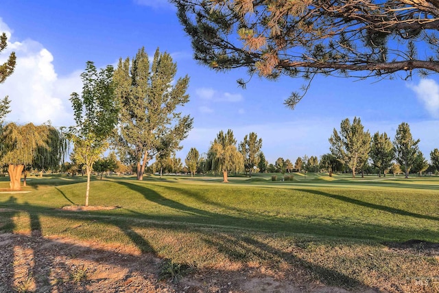 view of home's community featuring a lawn and golf course view