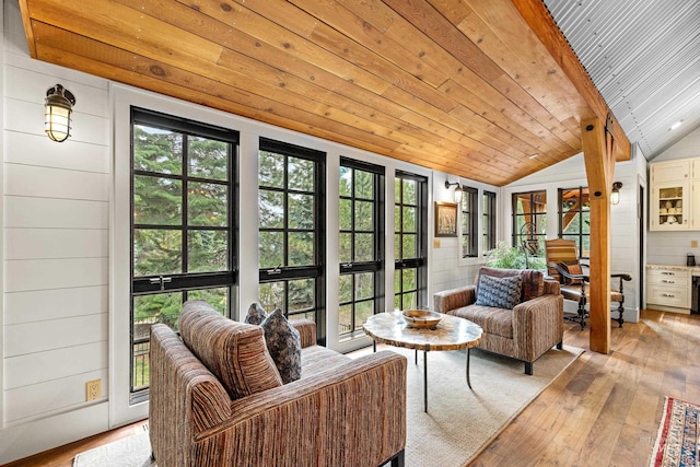 sunroom / solarium with lofted ceiling, wood-type flooring, french doors, wood ceiling, and an outdoor hangout area