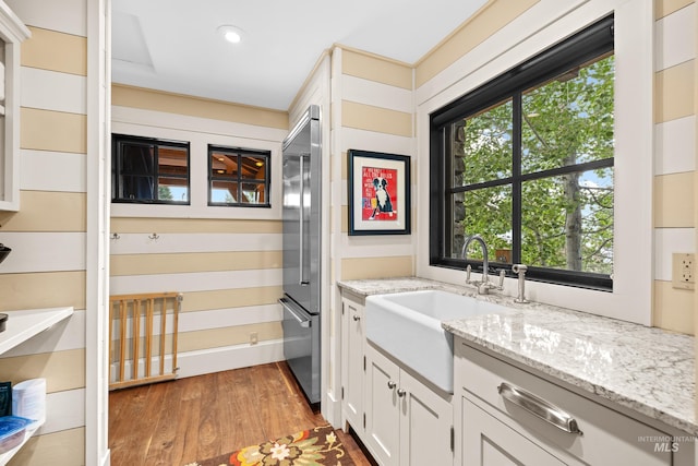 bathroom with wood finished floors, vanity, and recessed lighting