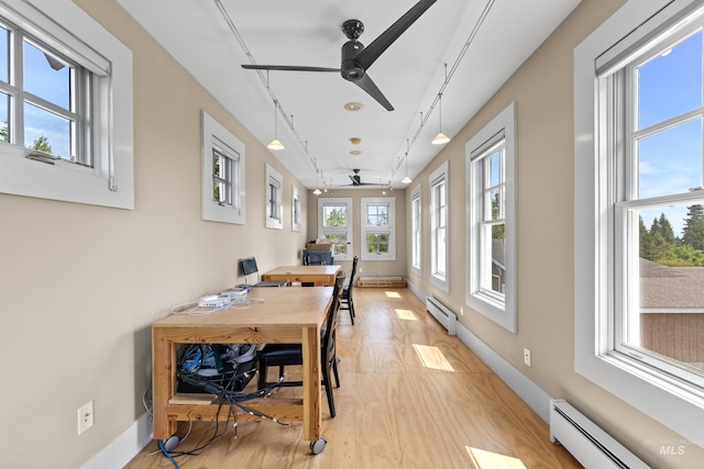 dining space with a baseboard heating unit, baseboards, an office area, and ceiling fan