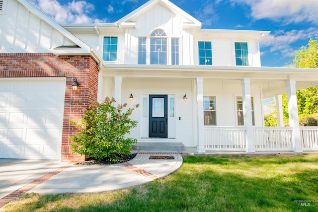 6174 N Queensbury Pl, Boise, ID 83713 - view of front facade with a porch, brick siding, a garage, and board and batten siding