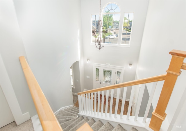 6174 N Queensbury Pl, Boise, ID 83713 - stairs with a towering ceiling, arched walkways, a chandelier, and baseboards