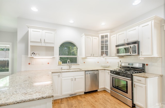 6174 N Queensbury Pl, Boise, ID 83713 - kitchen featuring appliances with stainless steel finishes, a sink, open shelves, light stone counters, and recessed lighting