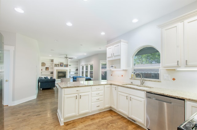 6174 N Queensbury Pl, Boise, ID 83713 - kitchen featuring dishwasher, a sink, a peninsula, ceiling fan, and a fireplace