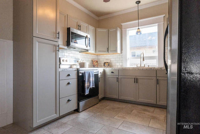 707 9th Ave S, Nampa, ID 83651 - kitchen featuring appliances with stainless steel finishes, a sink, tasteful backsplash, ornamental molding, and pendant lighting