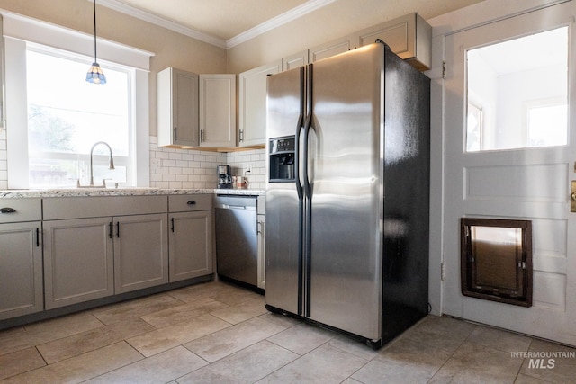 707 9th Ave S, Nampa, ID 83651 - kitchen with appliances with stainless steel finishes, a sink, decorative backsplash, ornamental molding, and decorative light fixtures
