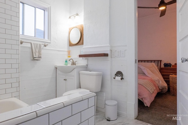 707 9th Ave S, Nampa, ID 83651 - ensuite bathroom with marble finish flooring, vanity, a wainscoted wall, toilet, and a bathtub