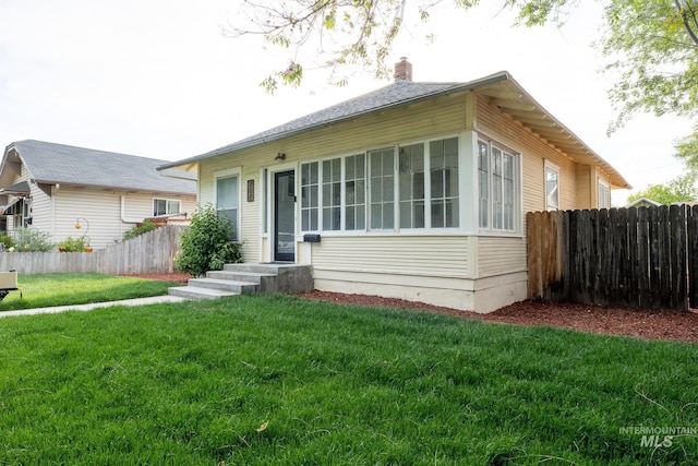 707 9th Ave S, Nampa, ID 83651 - view of front of home with a chimney and a sunroom