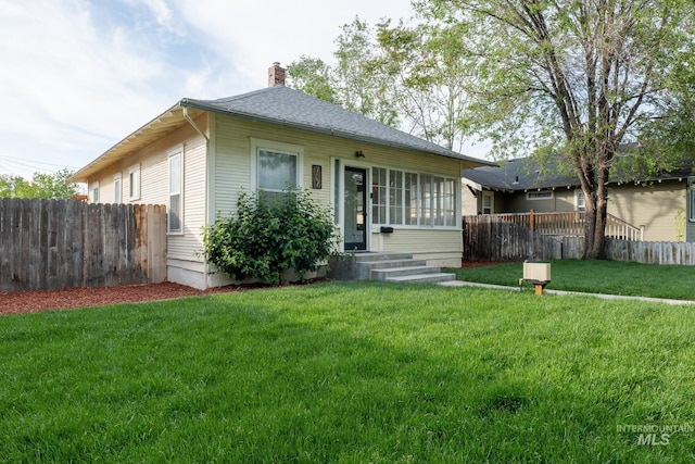 707 9th Ave S, Nampa, ID 83651 - rear view of house with a chimney and entry steps