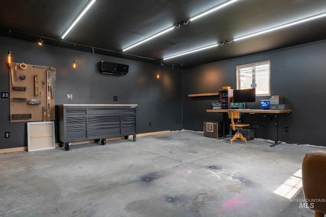 707 9th Ave S, Nampa, ID 83651 - garage with a workshop area, baseboards, and a wall mounted air conditioner