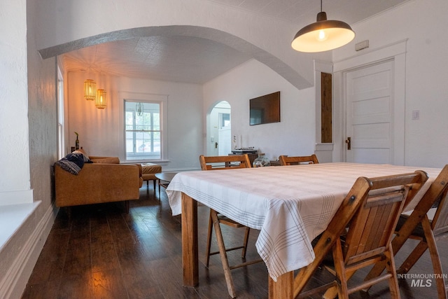 707 9th Ave S, Nampa, ID 83651 - dining room featuring arched walkways, wood-type flooring, and baseboards