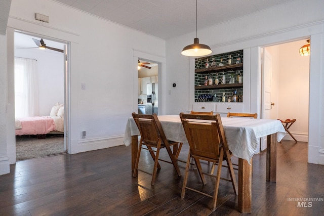 707 9th Ave S, Nampa, ID 83651 - dining space featuring ceiling fan, dark wood-type flooring, and bar