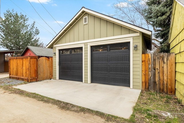 detached garage featuring fence