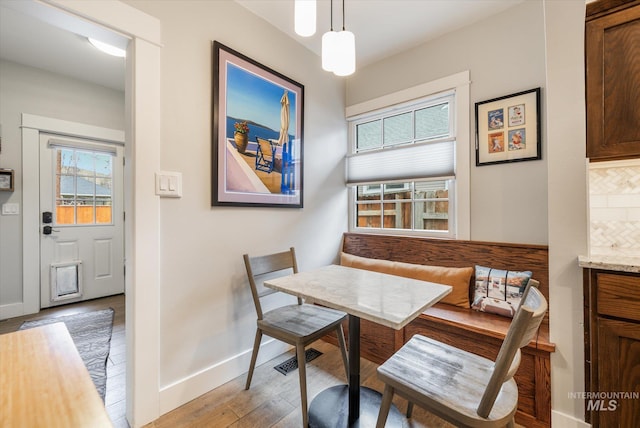 dining space featuring breakfast area, visible vents, baseboards, and light wood-style flooring