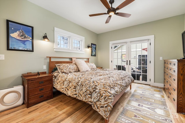 bedroom with a ceiling fan, access to outside, light wood-style floors, and french doors