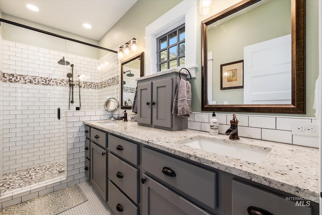 full bathroom with double vanity, recessed lighting, a stall shower, and a sink