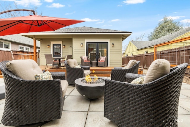 view of patio featuring a fire pit and fence