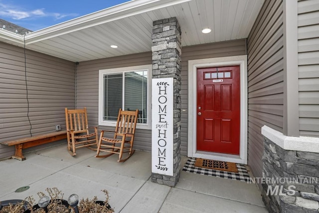 view of exterior entry with a porch