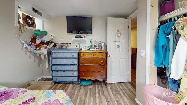 bedroom featuring visible vents and light wood-style flooring