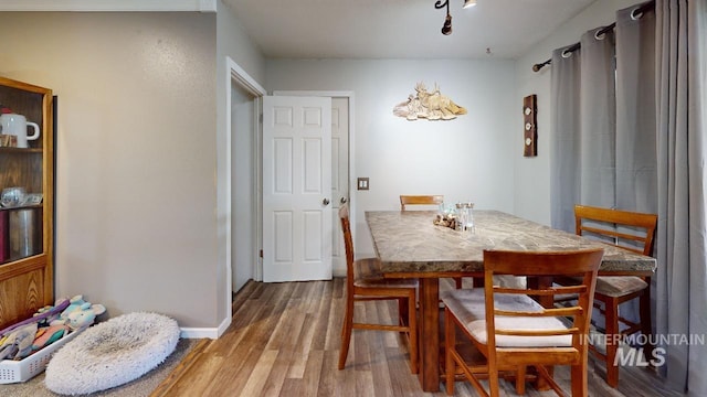 dining area with wood finished floors and baseboards