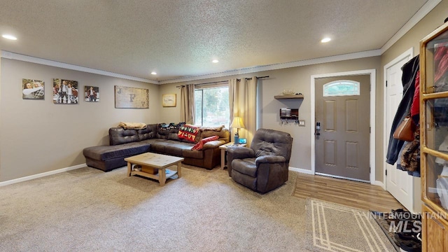 carpeted living room featuring baseboards, ornamental molding, a textured ceiling, and recessed lighting