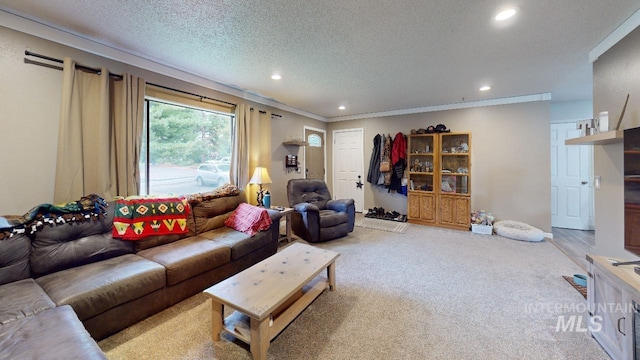 living room featuring light carpet, ornamental molding, a textured ceiling, and recessed lighting