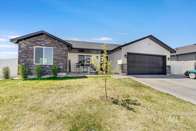 498 Jesse Ave, Twin Falls, ID 83301 - view of front of house with stone siding, concrete driveway, and a garage