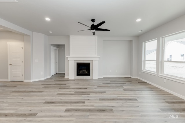 unfurnished living room featuring a ceiling fan, recessed lighting, baseboards, and light wood finished floors