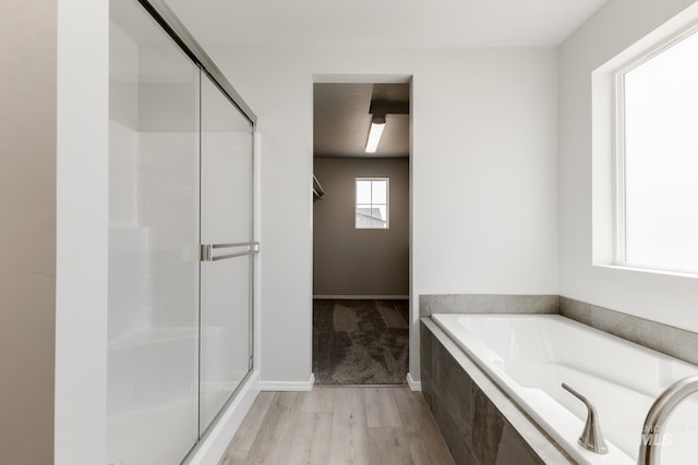 303 Gold Nugget Ave, Caldwell, ID 83605 - full bath featuring a shower stall, baseboards, a bath, and wood finished floors