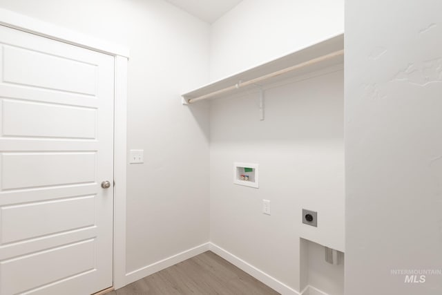 laundry area featuring baseboards, hookup for an electric dryer, laundry area, washer hookup, and light wood-style floors