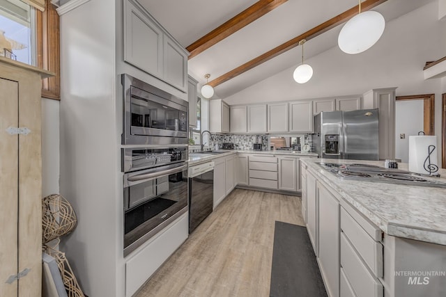 300 N 10th St, Payette, ID 83661 - kitchen with appliances with stainless steel finishes, beam ceiling, light countertops, decorative backsplash, and light wood-style floors