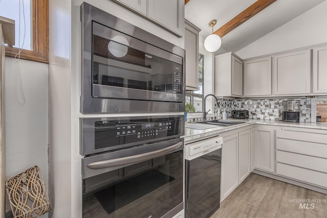 300 N 10th St, Payette, ID 83661 - kitchen featuring stainless steel appliances, decorative backsplash, and light wood-style floors