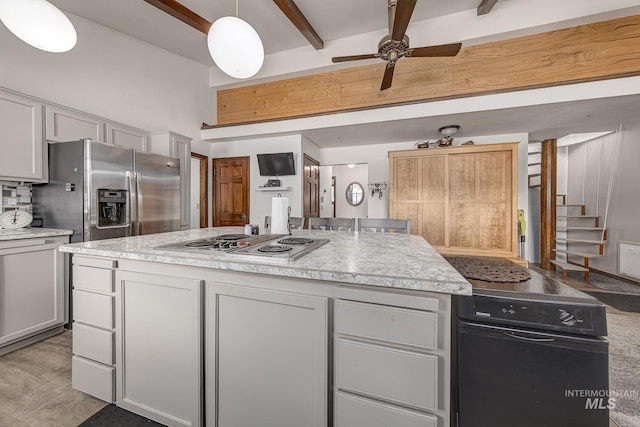 300 N 10th St, Payette, ID 83661 - kitchen featuring stainless steel appliances, beam ceiling, a ceiling fan, light countertops, and a center island