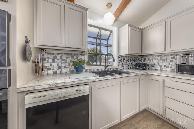 300 N 10th St, Payette, ID 83661 - kitchen featuring dishwashing machine, tasteful backsplash, vaulted ceiling, hanging light fixtures, and gray cabinetry