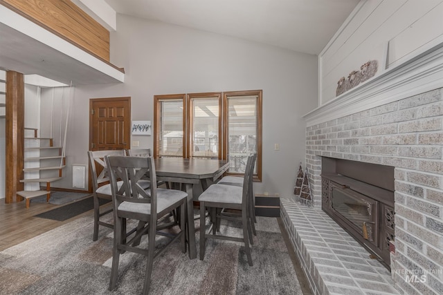 300 N 10th St, Payette, ID 83661 - dining area with stairs, a fireplace, wood finished floors, and high vaulted ceiling