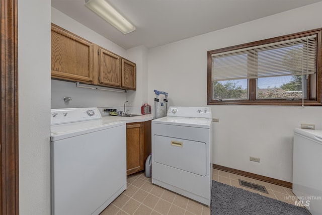 300 N 10th St, Payette, ID 83661 - laundry area with cabinet space, washing machine and dryer, and light tile patterned flooring