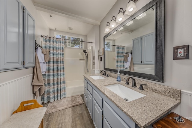 300 N 10th St, Payette, ID 83661 - bathroom featuring double vanity, wainscoting, shower / bath combo with shower curtain, and wood finished floors